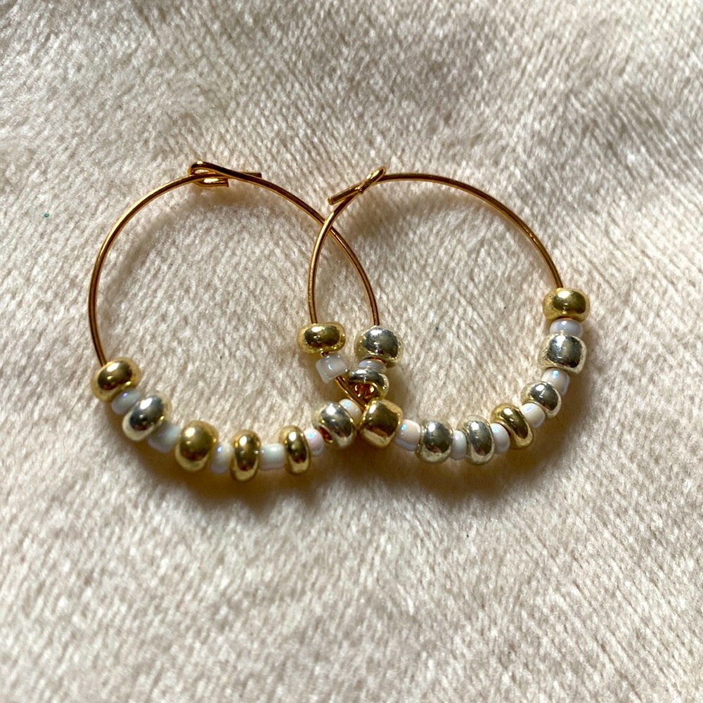 This is a set of earrings, gold rim with gold and white beads that I made